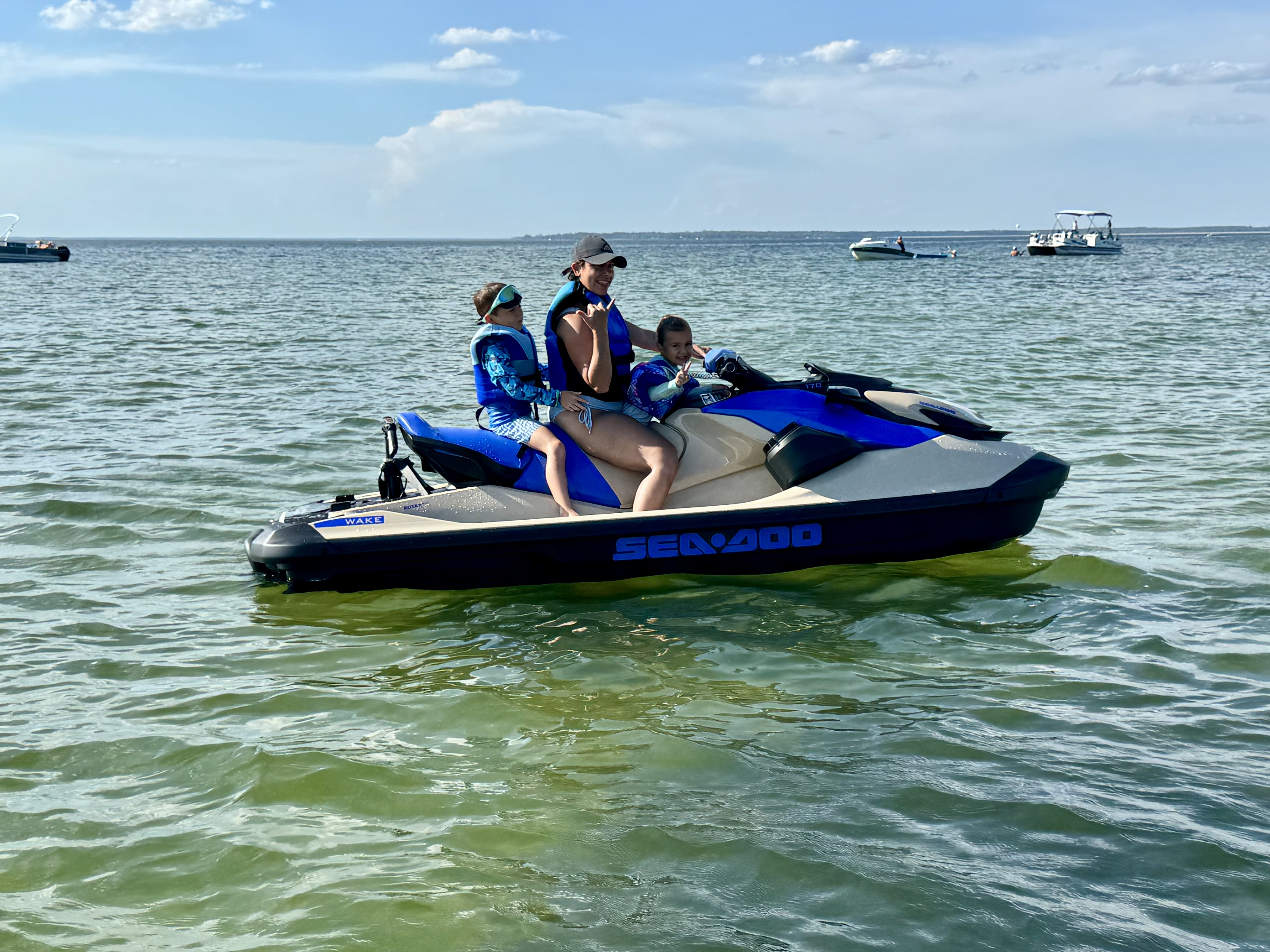 Kayla and two children enjoying a Sea-Doo jet ski ride on Charleston waters